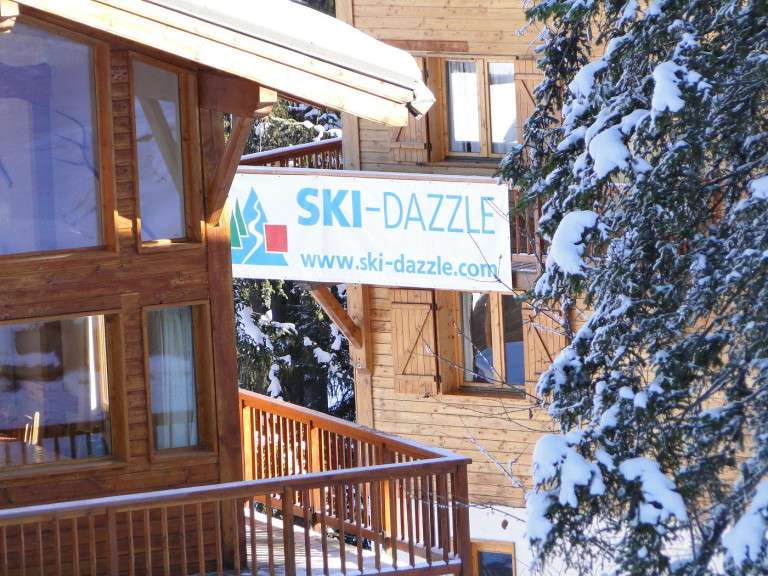 Guests enjoying a cozy ski chalet holiday in La Tania with stunning alpine views and warm hospitality.