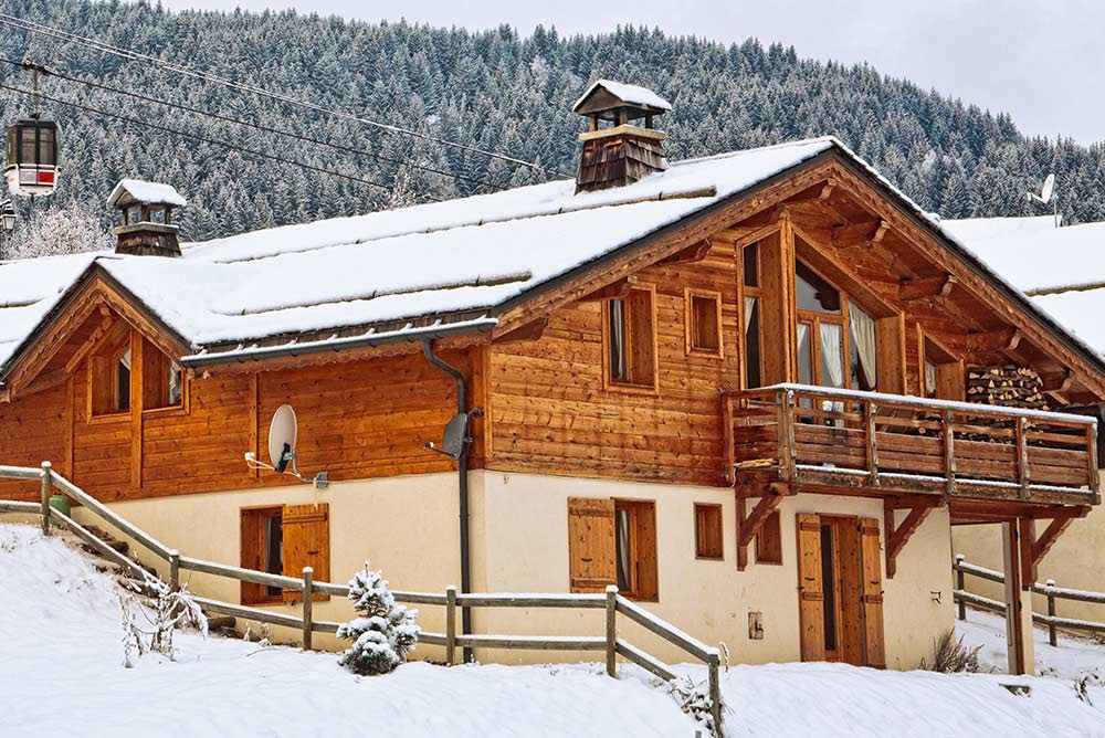 snow covered wooden mountain chalet