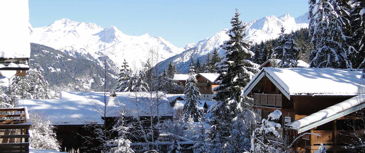 Guest relaxing in a ski chalet hot tub with scenic mountain views and wellness amenities.