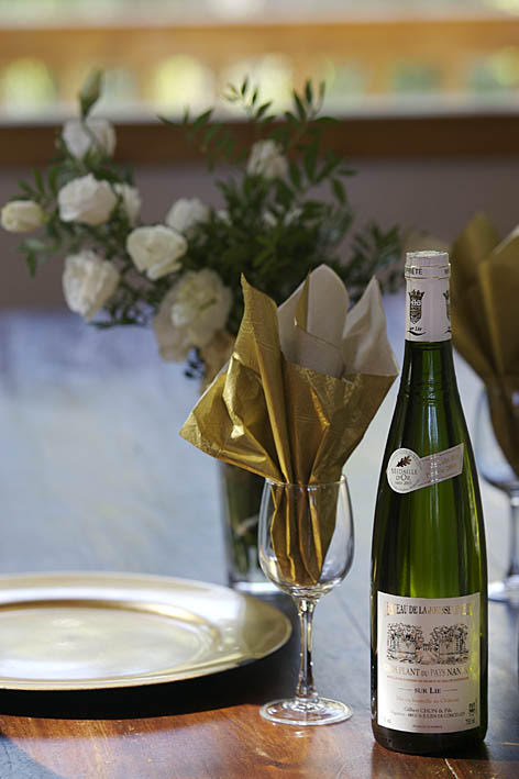 Elegant Table Setting with White Wine and Floral Centerpiece
